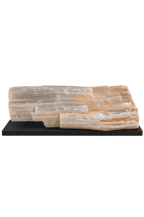 A polished petrosal stone slab with layered translucent crystal structures in pale cream, beige, and soft tan tones, displayed on a rectangular black base against a plain white background.